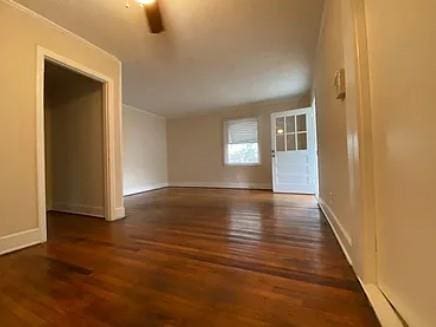 spare room with wood finished floors and baseboards