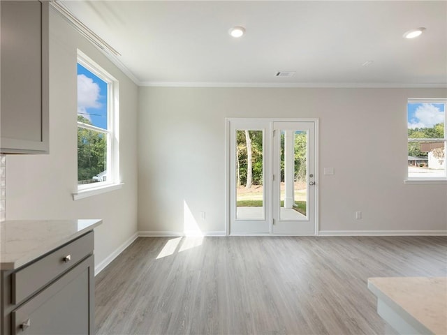 interior space with light hardwood / wood-style floors and ornamental molding