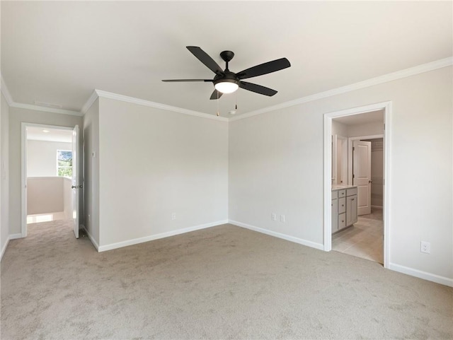 carpeted empty room featuring ceiling fan and crown molding