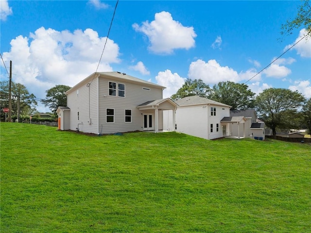 back of house with a lawn