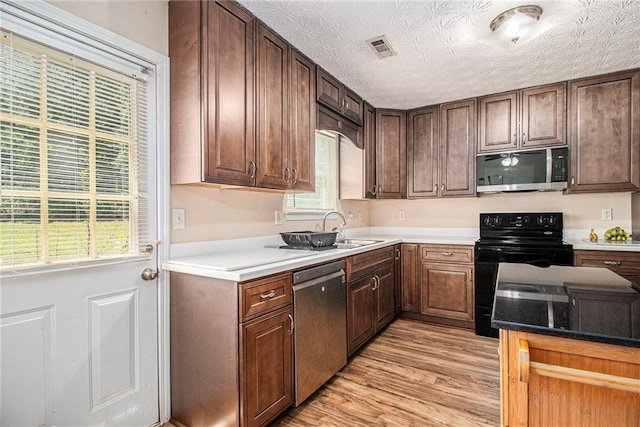 45 Ratliff Dr, Covington, GA 30016 - kitchen featuring appliances with stainless steel finishes and light wood finished floors