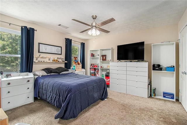 45 Ratliff Dr, Covington, GA 30016 - carpeted bedroom with a textured ceiling and ceiling fan
