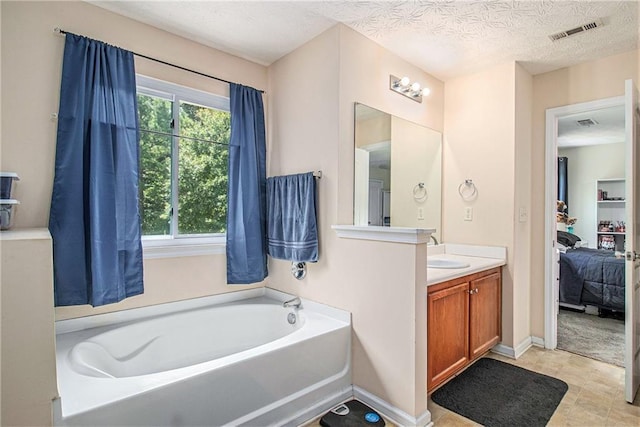 45 Ratliff Dr, Covington, GA 30016 - bathroom with vanity, a garden tub, and a textured ceiling
