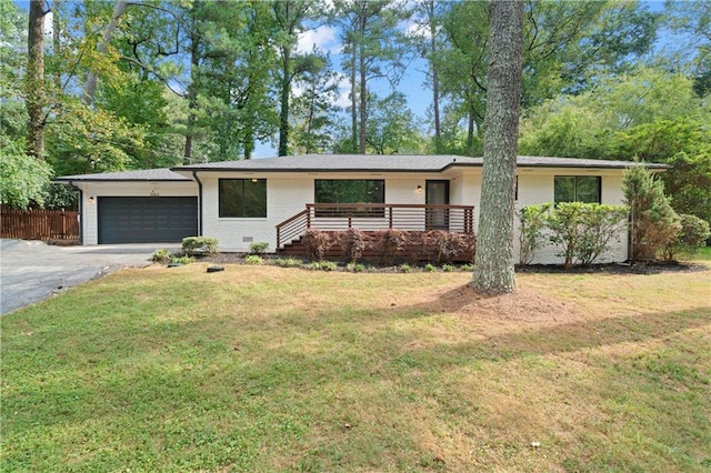 single story home featuring a garage, brick siding, fence, driveway, and a front yard