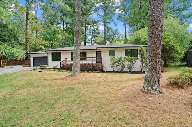 ranch-style house with a front lawn, brick siding, driveway, and an attached garage