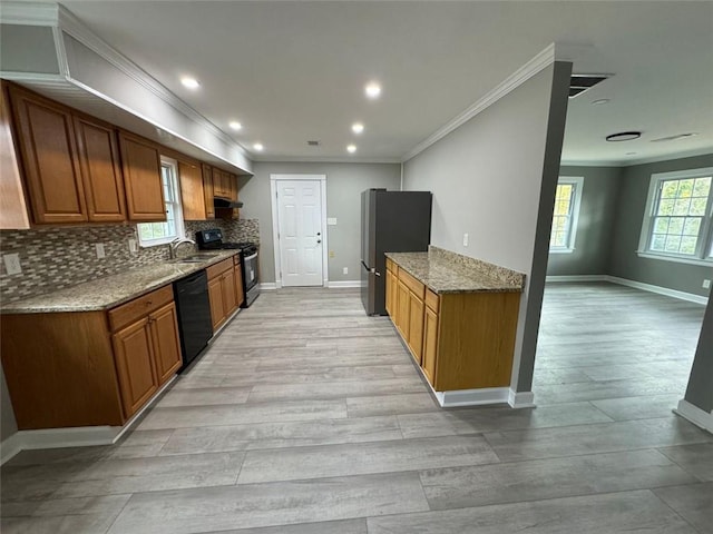 kitchen with black appliances, ornamental molding, baseboards, a sink, and decorative backsplash