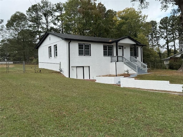 view of front of house featuring brick siding and view of scattered trees