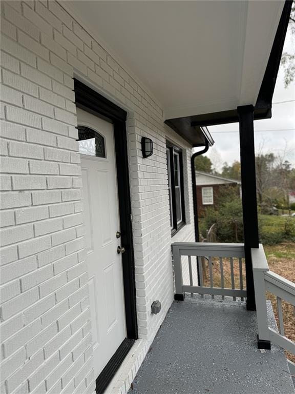 property entrance featuring brick siding