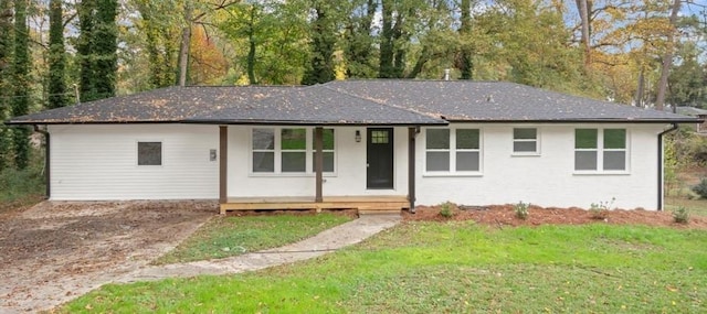 ranch-style house with covered porch and a front yard