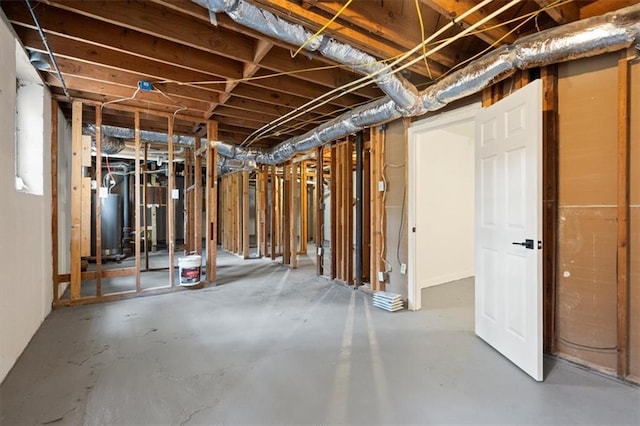 unfinished basement featuring gas water heater