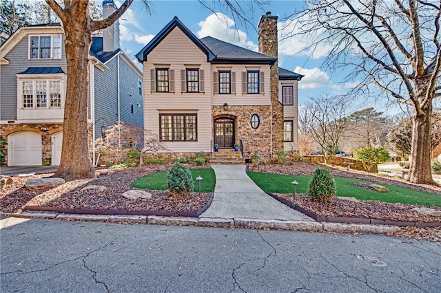 view of front of property with a garage and a front lawn