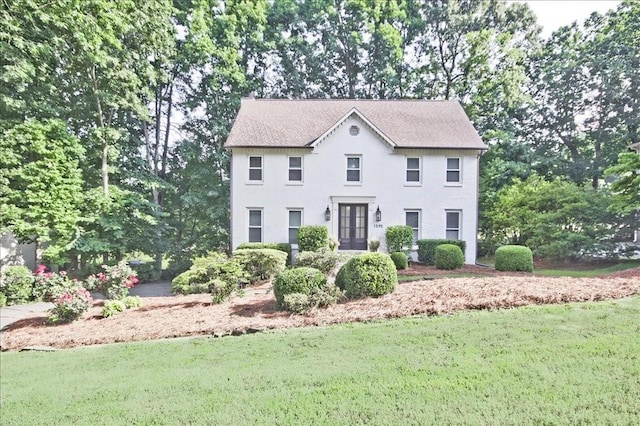 colonial inspired home with a front yard