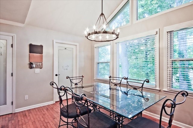 dining room with a notable chandelier, wood finished floors, and baseboards