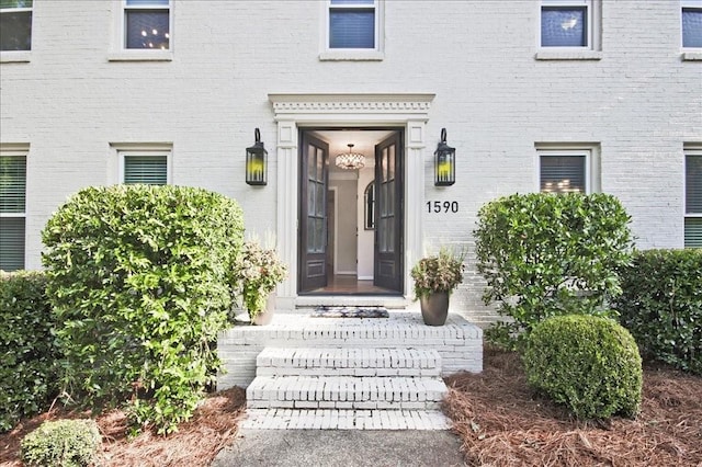 doorway to property featuring brick siding