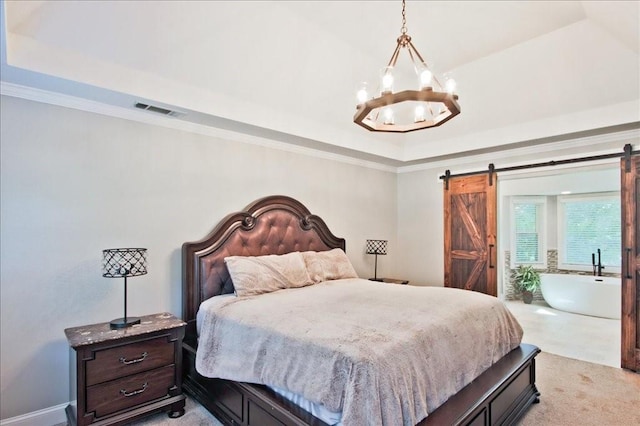 bedroom featuring visible vents, a tray ceiling, crown molding, a barn door, and a notable chandelier