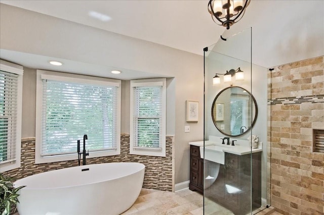 full bathroom featuring a freestanding bath, tile walls, vanity, and a tile shower