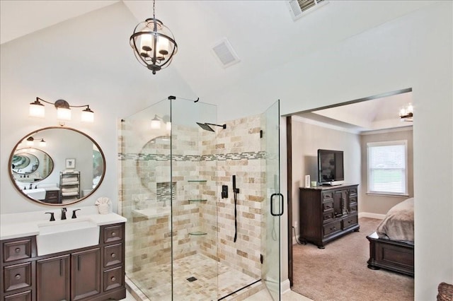 ensuite bathroom featuring vanity, a shower stall, visible vents, and ensuite bathroom