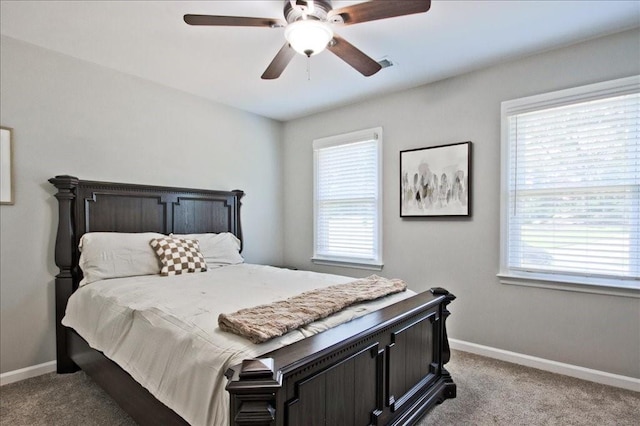 bedroom with ceiling fan, baseboards, and carpet floors