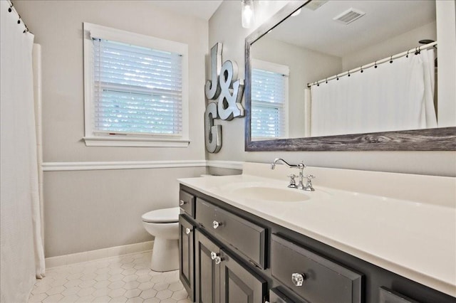 full bath with tile patterned flooring, visible vents, baseboards, toilet, and vanity