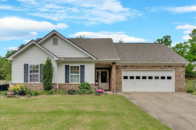 view of front of home with a front yard and a garage