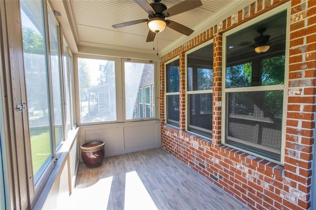 sunroom featuring a ceiling fan