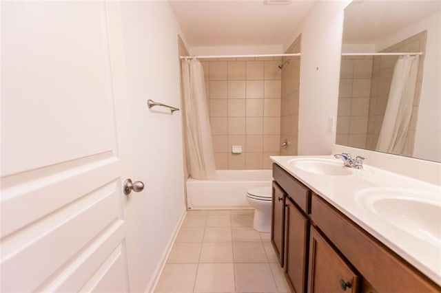 bathroom with tile patterned flooring, shower / tub combo with curtain, double vanity, toilet, and baseboards