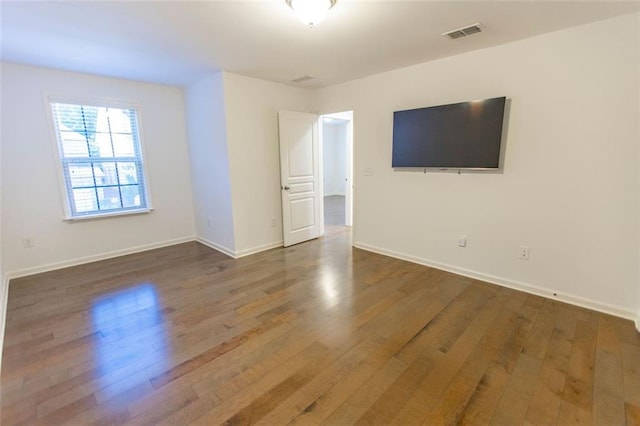unfurnished room featuring wood finished floors and baseboards