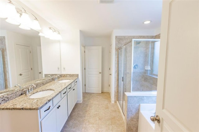 bathroom featuring a stall shower, double vanity, tile patterned flooring, a bath, and baseboards