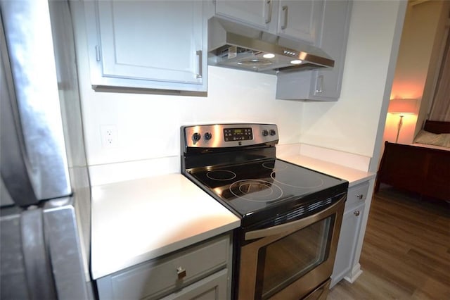 kitchen with hardwood / wood-style floors and stainless steel range with electric cooktop