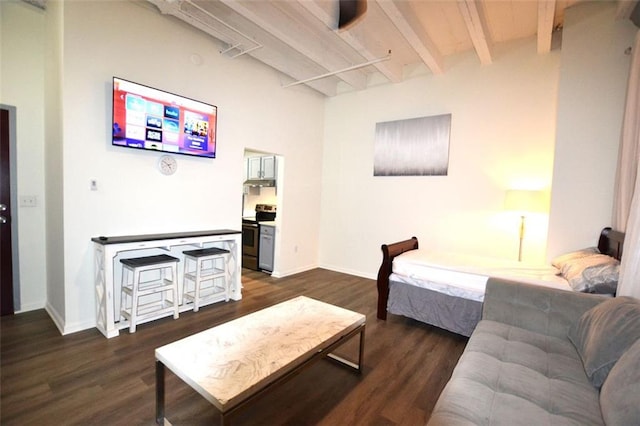 bedroom featuring beamed ceiling and dark wood-type flooring