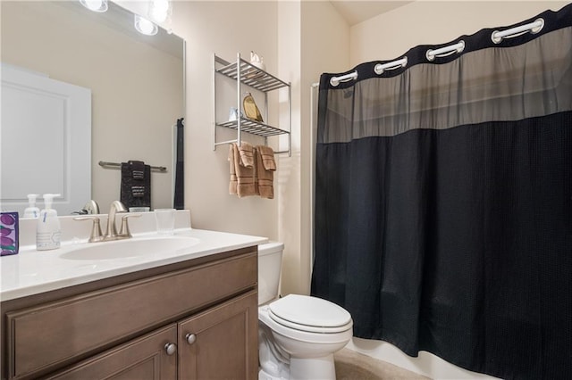 bathroom featuring walk in shower, vanity, and toilet