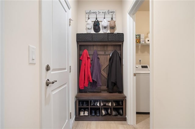 mudroom featuring light wood-type flooring and washer / dryer