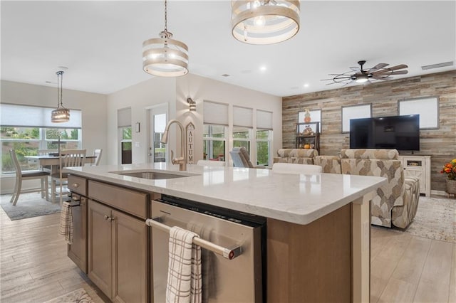 kitchen featuring light hardwood / wood-style flooring, ceiling fan, sink, and stainless steel dishwasher