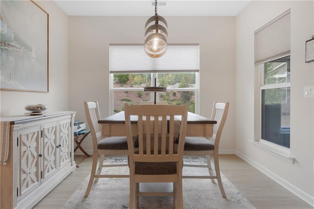 dining space with light hardwood / wood-style floors