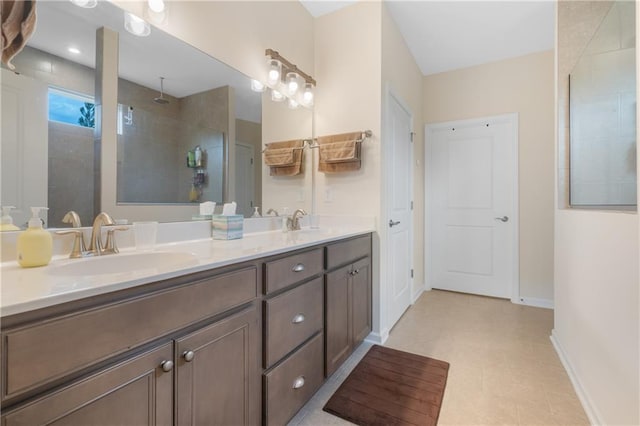 bathroom with vanity, tile patterned flooring, and a tile shower