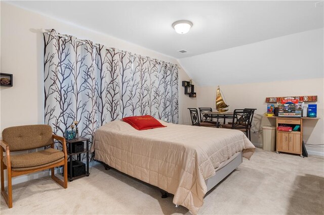 carpeted bedroom featuring vaulted ceiling