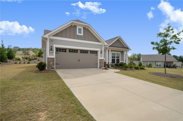 craftsman inspired home with a garage and a front lawn