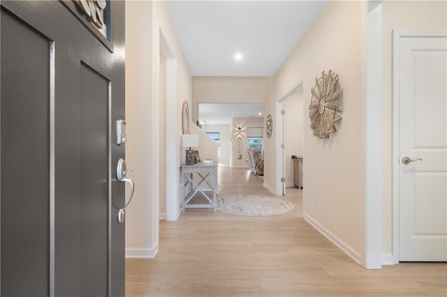 hallway with light hardwood / wood-style floors