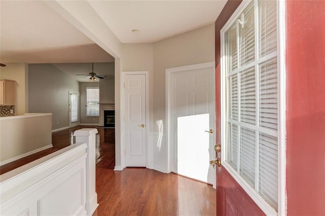 hall with wood finished floors and baseboards