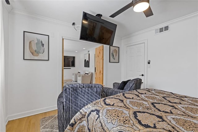 10 26th St NW Unit A2, Atlanta, GA 30309 - bedroom featuring a ceiling fan, crown molding, light wood finished floors, baseboards, and visible vents