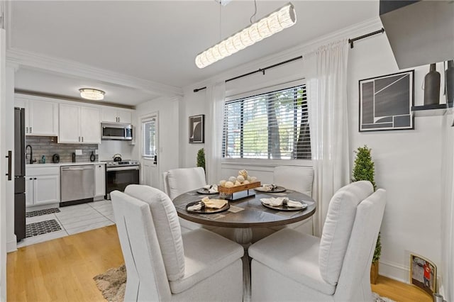 10 26th St NW Unit A2, Atlanta, GA 30309 - dining area featuring crown molding and light wood finished floors