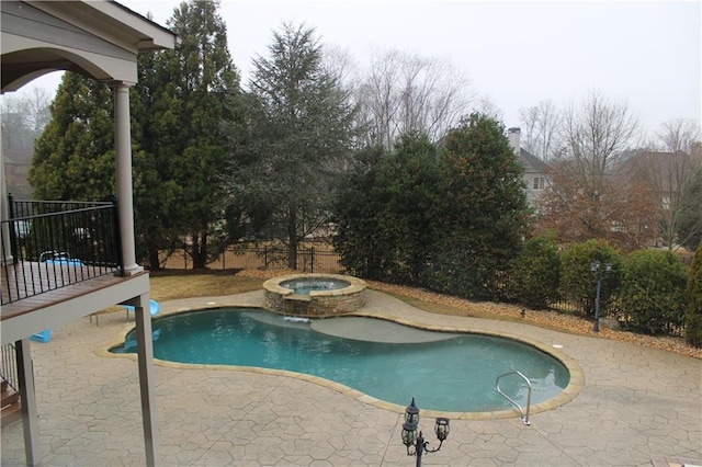 view of pool with a fenced in pool, a patio, fence, and an in ground hot tub