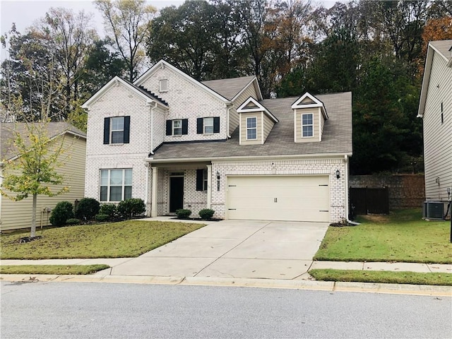 view of front of house featuring central air condition unit, a garage, and a front lawn