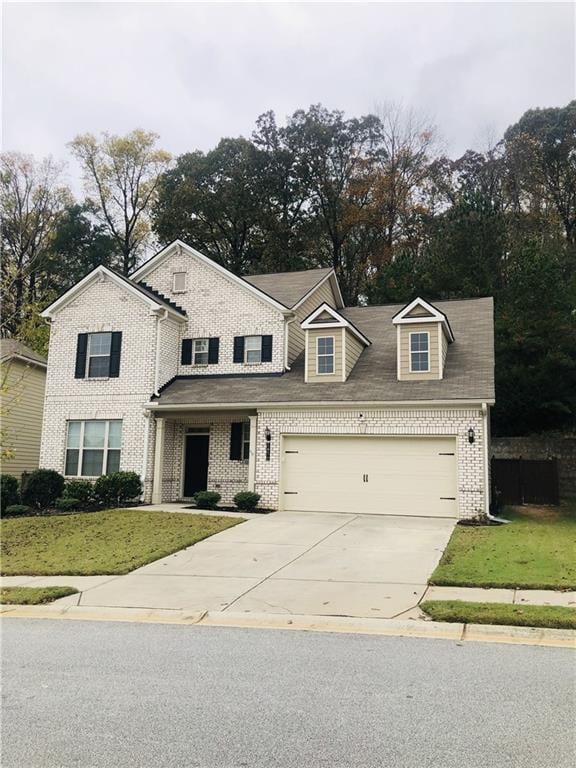 view of front of house featuring a front yard and a garage