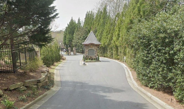 9675 Almaviva Dr, Alpharetta, GA 30022 - view of asphalt road featuring curbs and a gate