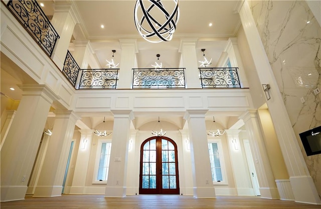 9675 Almaviva Dr, Alpharetta, GA 30022 - foyer entrance with a high ceiling, a chandelier, ornamental molding, french doors, and a decorative wall