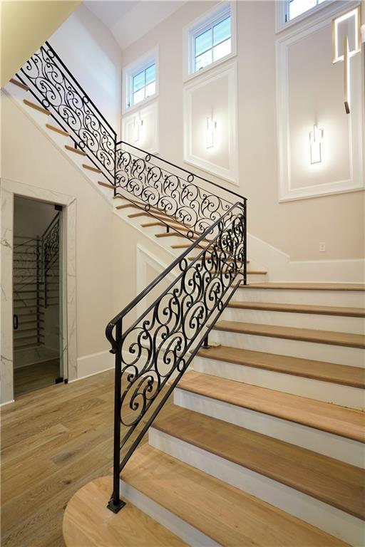 9675 Almaviva Dr, Alpharetta, GA 30022 - stairs featuring wood finished floors