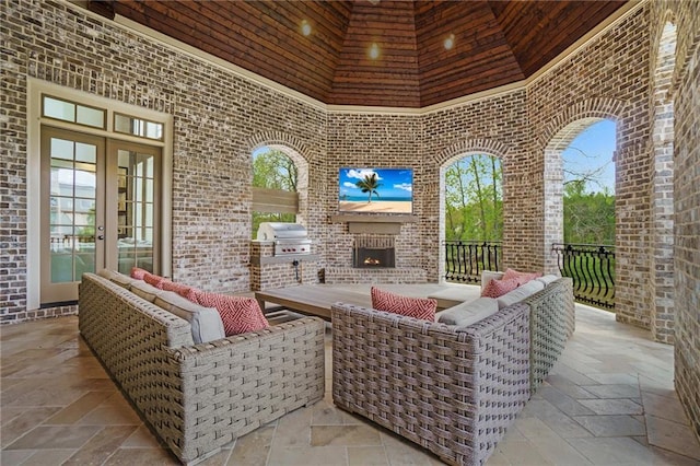 view of patio / terrace with grilling area, french doors, exterior kitchen, and an outdoor living space