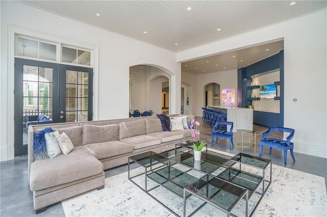 living room with concrete flooring and french doors