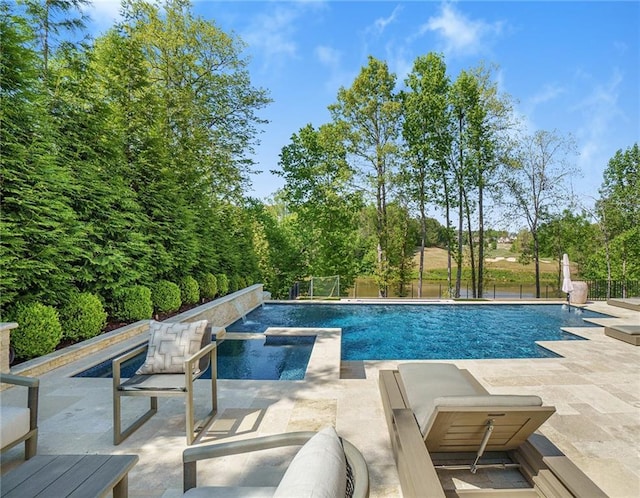 view of pool featuring a patio and an in ground hot tub